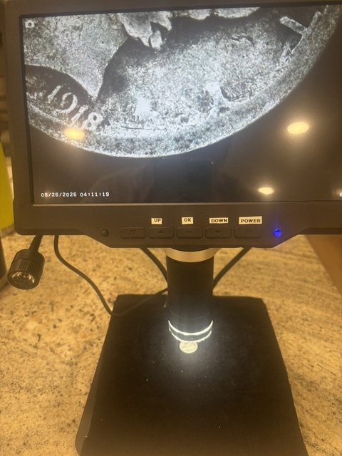 A 1918 silver coin examined under a digital microscope
